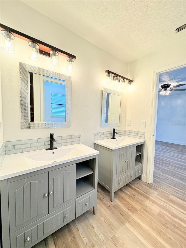 bathroom featuring vanity, hardwood / wood-style floors, and a textured ceiling