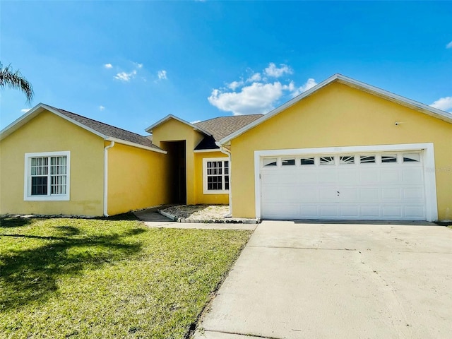 ranch-style house featuring an attached garage, driveway, a front yard, and stucco siding