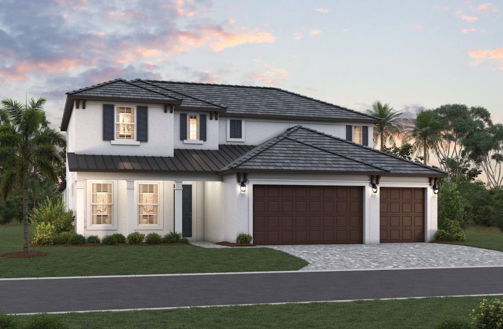 view of front of house featuring a garage and a yard