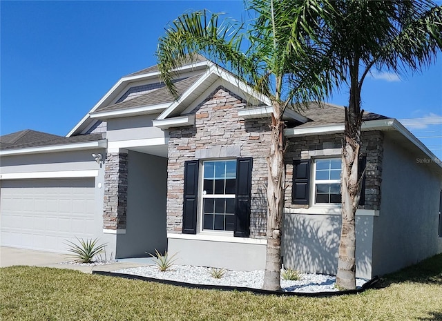 view of front of property featuring an attached garage, stone siding, and stucco siding