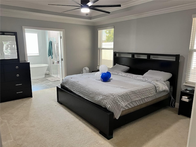 bedroom with connected bathroom, light colored carpet, ceiling fan, baseboards, and crown molding