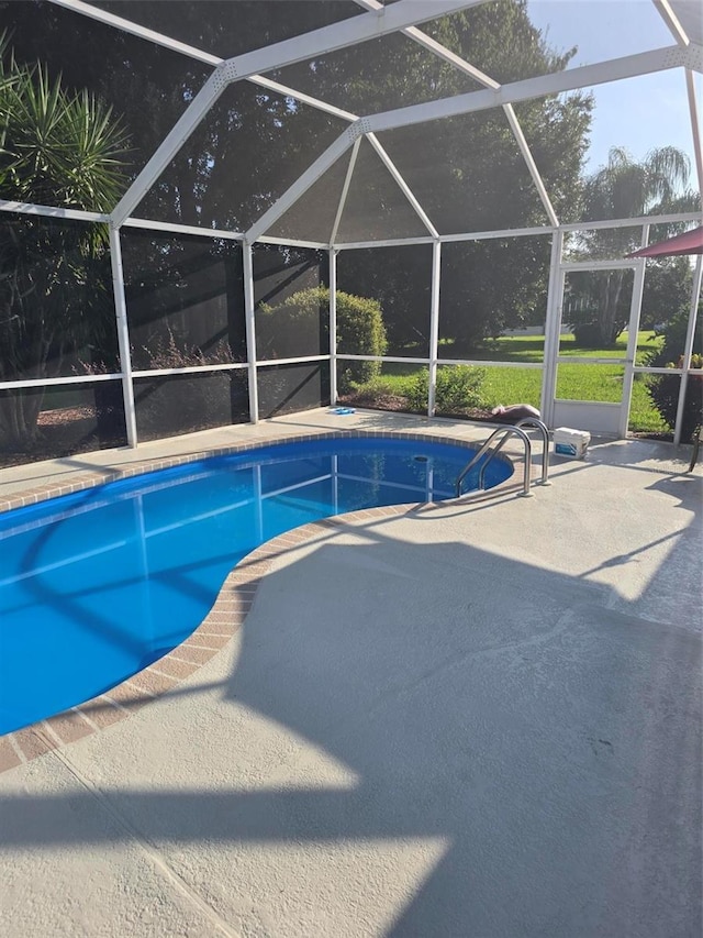 view of pool featuring a lanai and a patio