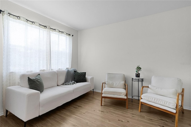 living area featuring wood finished floors and baseboards