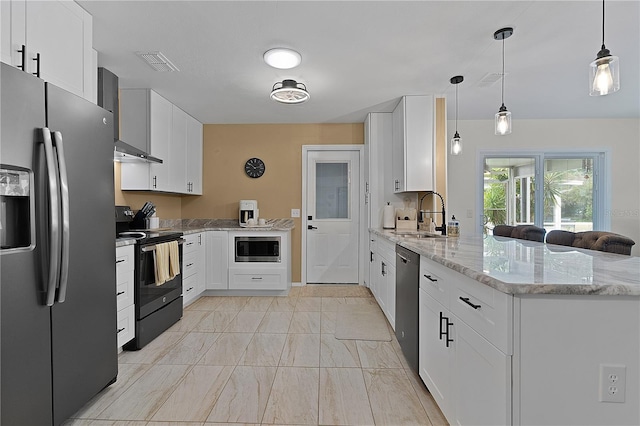 kitchen with appliances with stainless steel finishes, a sink, a peninsula, and white cabinets
