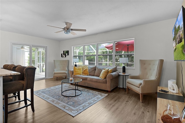 living area featuring ceiling fan and light wood finished floors