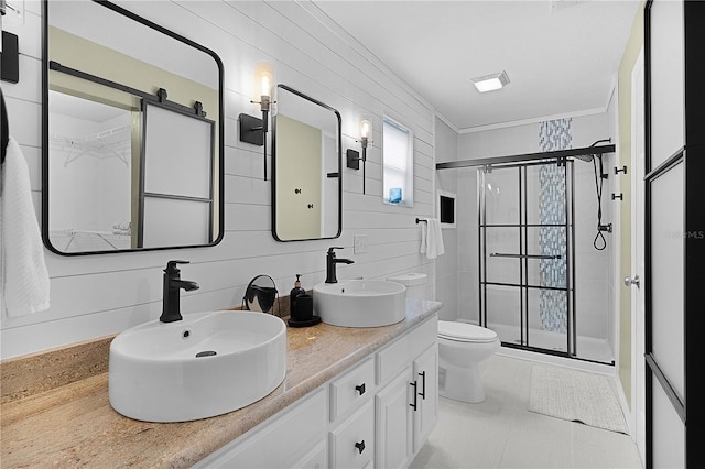 full bathroom featuring a shower stall, double vanity, and toilet