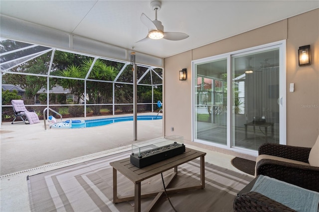 swimming pool featuring a patio, ceiling fan, and a lanai