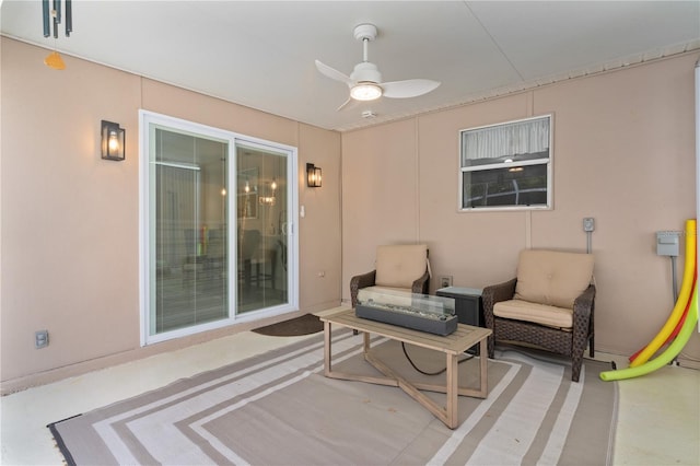 living area with ceiling fan