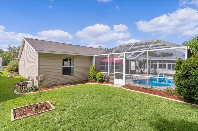 rear view of property featuring a yard, an outdoor pool, a lanai, and a patio