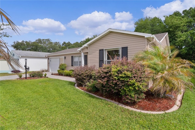 ranch-style home with an attached garage, driveway, and a front yard