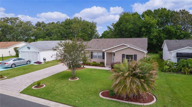 ranch-style home featuring driveway, a front yard, and a garage