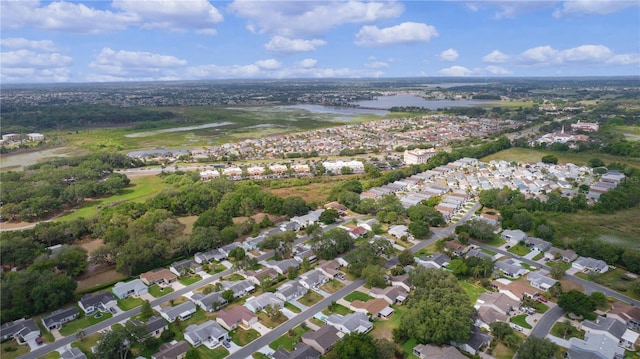 aerial view of property's location with a nearby body of water and nearby suburban area