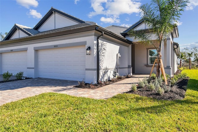 view of front of house with a garage and a front lawn