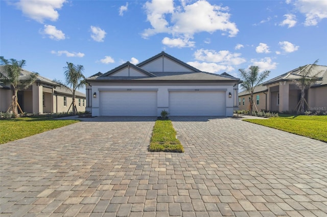 view of front of property featuring a garage and a front yard