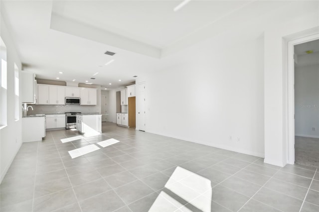 unfurnished living room featuring light tile patterned floors