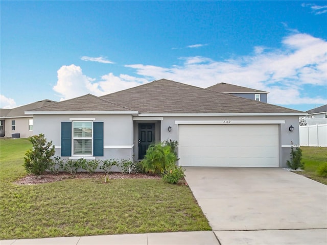 ranch-style home featuring a garage and a front yard