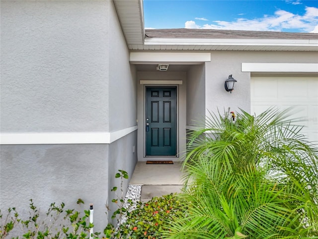 doorway to property with a garage