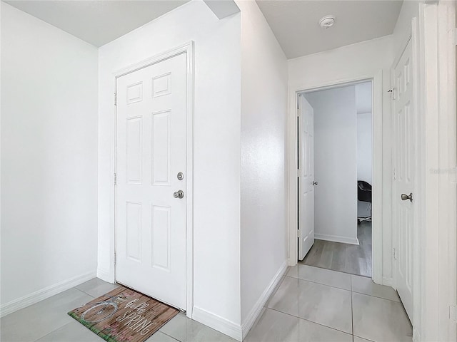 corridor featuring light tile patterned floors