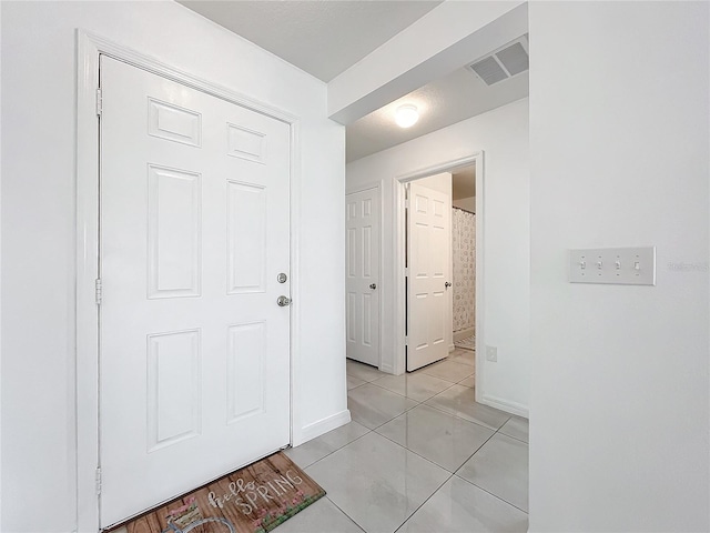 hallway featuring light tile patterned floors