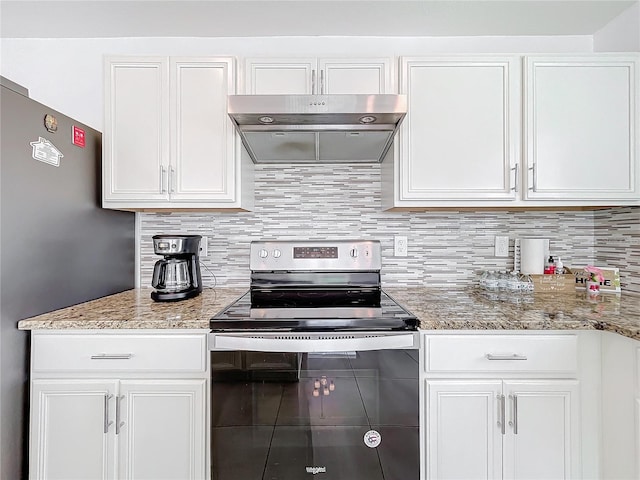 kitchen featuring light stone counters, decorative backsplash, stainless steel electric stove, and white cabinets