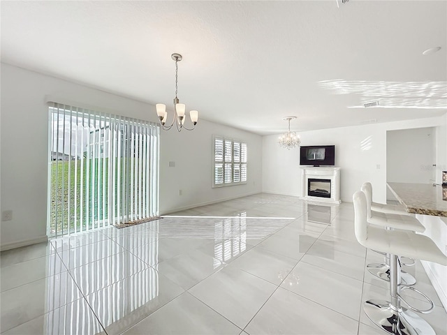 interior space featuring light tile patterned floors and a chandelier