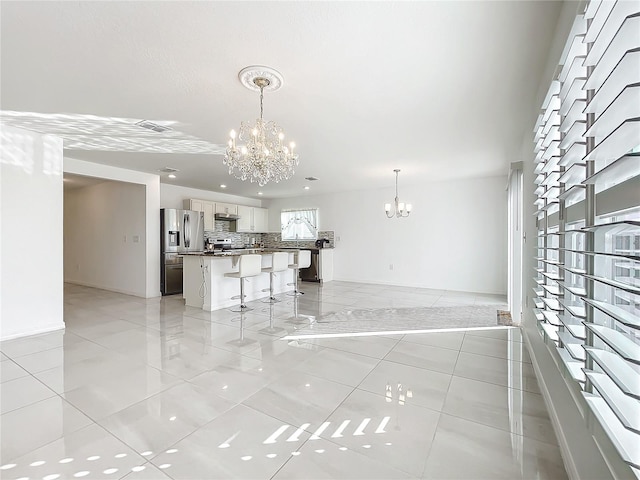 interior space featuring light tile patterned flooring and a notable chandelier