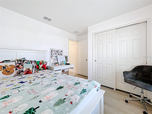 bedroom featuring light hardwood / wood-style floors and a closet