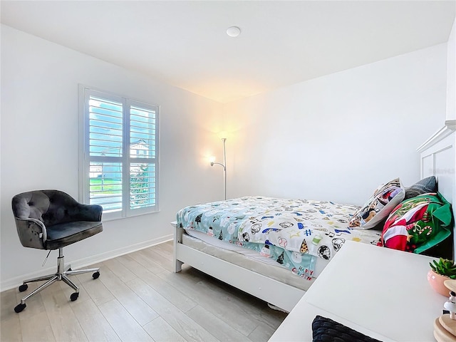 bedroom with hardwood / wood-style flooring