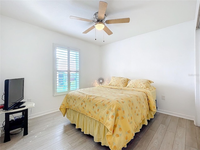 bedroom with ceiling fan and wood-type flooring