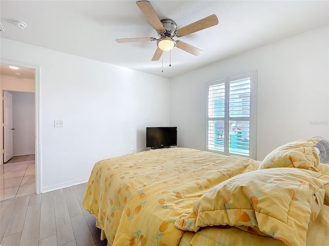 bedroom with ceiling fan and light wood-type flooring