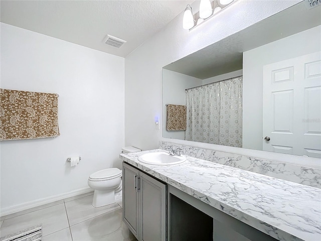 bathroom featuring vanity, toilet, tile patterned floors, a textured ceiling, and a shower with curtain