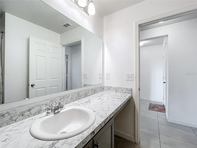 bathroom featuring tile patterned floors and vanity