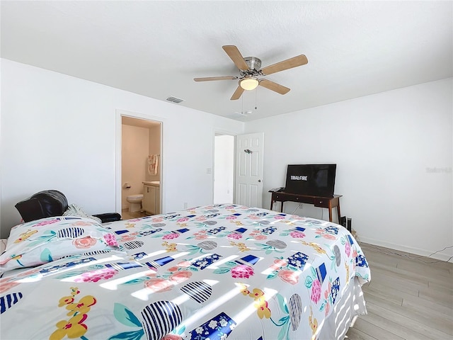 bedroom featuring ceiling fan, connected bathroom, and light hardwood / wood-style flooring