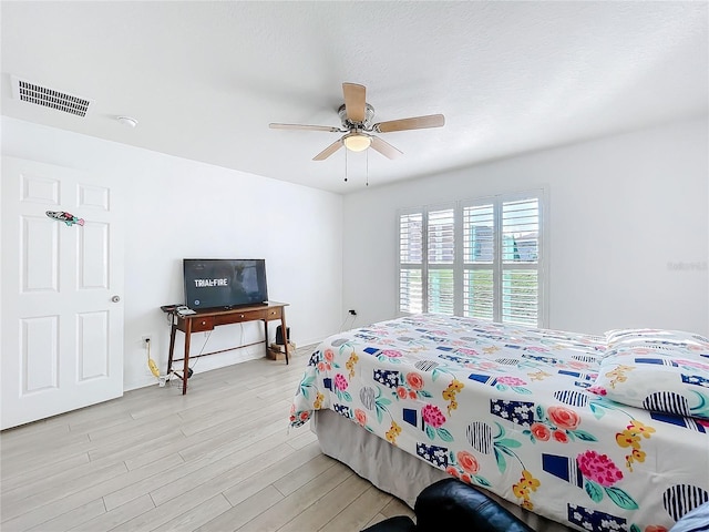 bedroom with light hardwood / wood-style flooring and ceiling fan