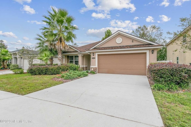 view of front of home featuring a front yard and a garage