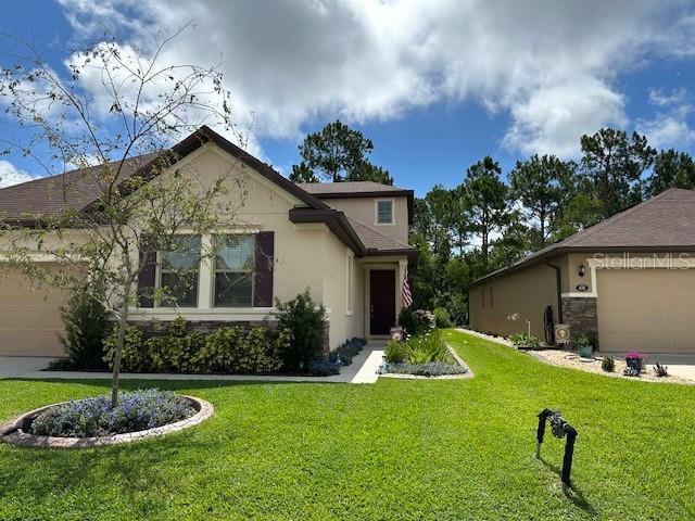 view of front of property with a front lawn and a garage