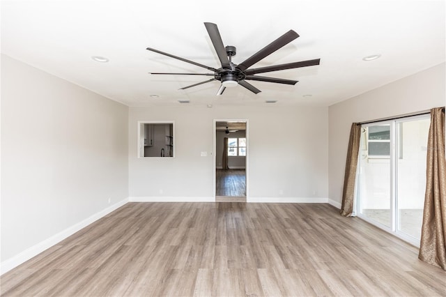 empty room with light wood finished floors, ceiling fan, baseboards, and recessed lighting
