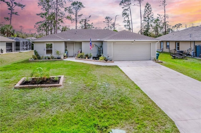 ranch-style home with an attached garage, driveway, a front yard, and stucco siding