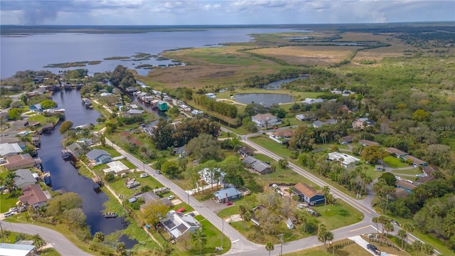 drone / aerial view featuring a water view and a residential view