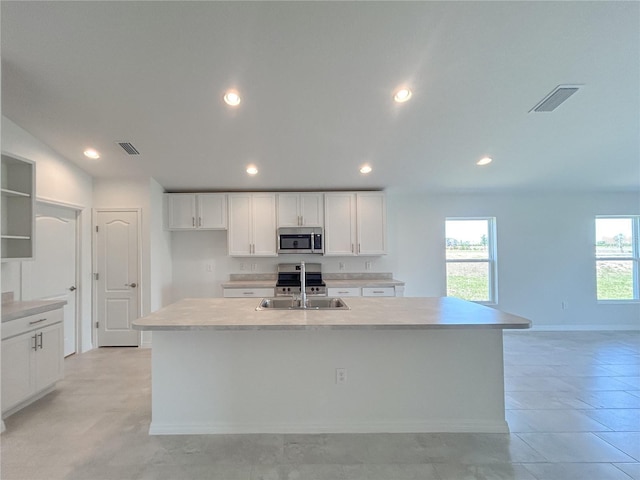 1212 Caloosa Ridge Ave, Babson Park, FL 33827 - kitchen featuring stainless steel microwave, a sink, white cabinetry, light countertops, and recessed lighting