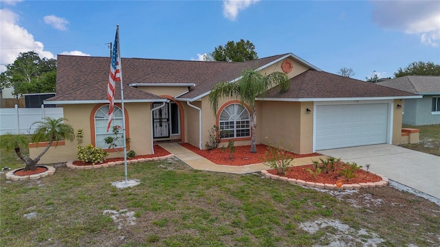 ranch-style home with driveway, a shingled roof, an attached garage, a front lawn, and stucco siding