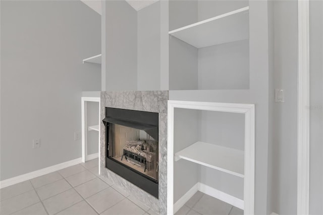 interior details with a fireplace and baseboards