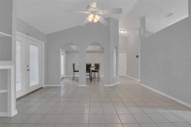 interior space with arched walkways, light tile patterned flooring, visible vents, baseboards, and french doors