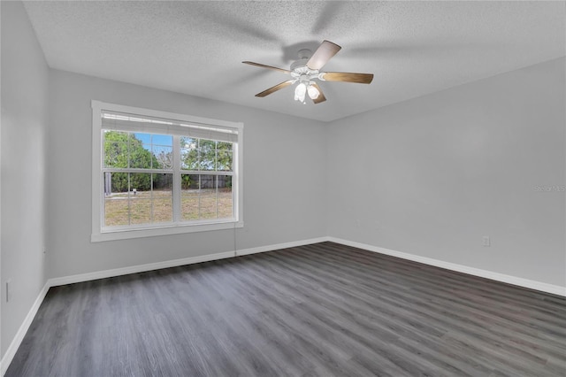 spare room featuring ceiling fan, a textured ceiling, baseboards, and dark wood-style flooring