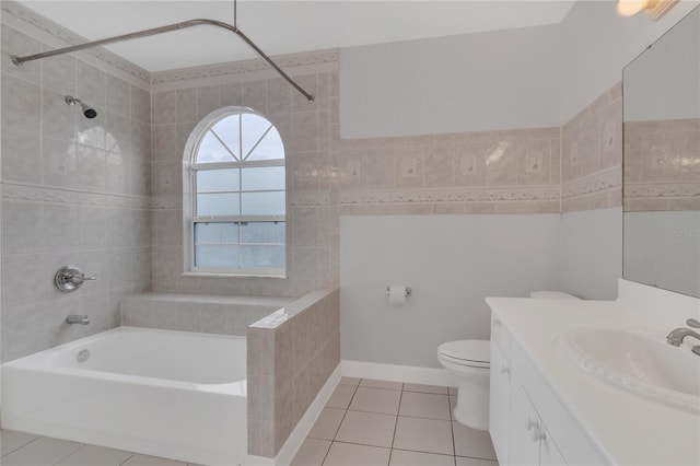 full bathroom with shower / bath combination, toilet, tile patterned flooring, vanity, and tile walls