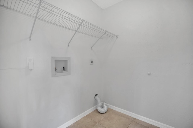 clothes washing area with hookup for a washing machine, laundry area, baseboards, tile patterned floors, and electric dryer hookup