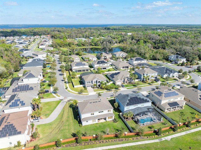 drone / aerial view with a forest view and a residential view