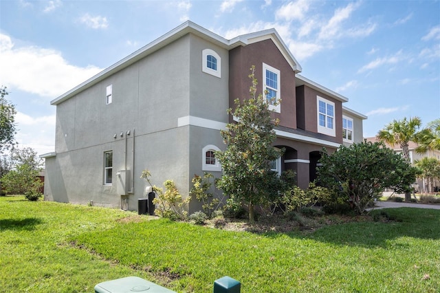 view of property exterior featuring a yard and stucco siding