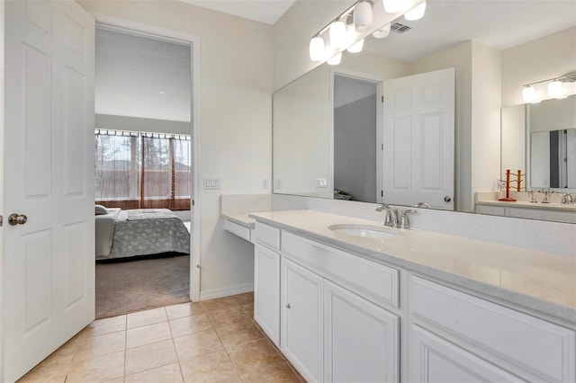 ensuite bathroom with tile patterned flooring, visible vents, vanity, and ensuite bathroom