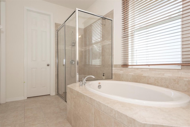 full bath with a stall shower, tile patterned flooring, and a garden tub